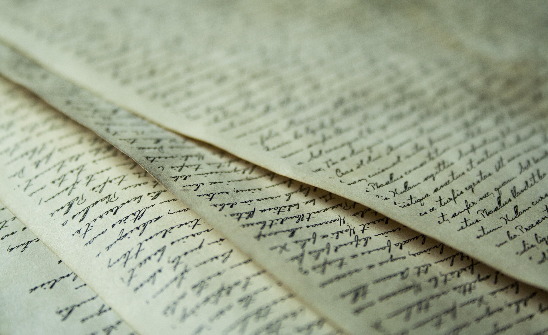 A picture showing three four letter pages stacked onto each other.